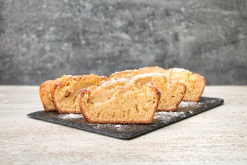apple pie, cut into equal pieces, sprinkled with powdered sugar
