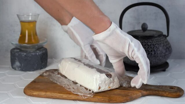 The chef makes traditional eastern dessert halva or sesame with raisin. 