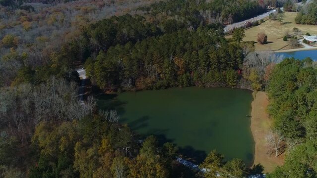 Completed aerial drone view of triangle lake surround by trees forest