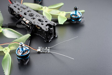 Racing quadcopter in carbon frame with propellers on a dark background.