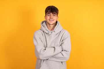 portrait of teen boy isolated on yellow background
