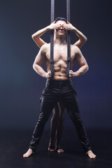 Circus performance arial, man and woman showing tricks.