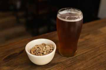 craft beer next to salted peanuts