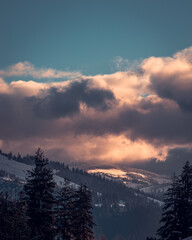 Amazing sunrise. Winter forest. High mountains with snow white peaks.  Location place Carpathian, Vatra Dornei, Bucovina, Suceava, Romania, Europe.