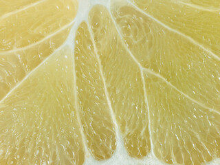 a slice of juicy fresh yellow aromatic bergamot very close in detail close-up macro. fruit background. pattern. citrus slice - obrazy, fototapety, plakaty