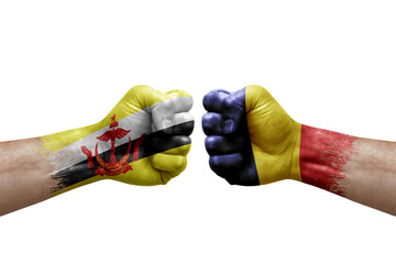 Two hands punch to each others on white background. Country flags painted fists, conflict crisis concept between brunei and chad