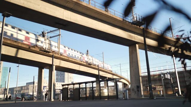 Zurich, Switzerland - February 9, 2022: Focus pull at passing train on the viaduct  of Toni Areal in Zurich