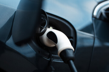 Fototapeta na wymiar Close-up of plug-in of EV car at charge station.