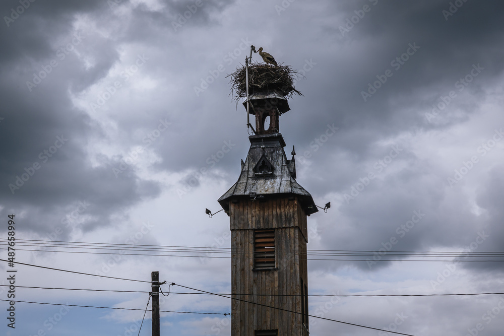 Poster Nest of white storks on a wooden tower in Miedzyrzecze Gorne village in Silesia region, Poland