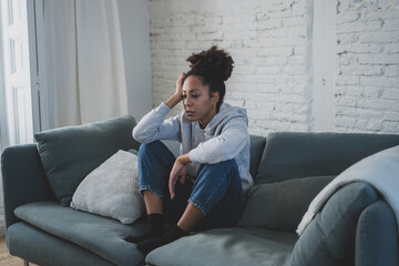 Lonely african american young woman suffering from depression, stress and mental health disorders