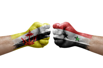 Two hands punch to each others on white background. Country flags painted fists, conflict crisis concept between brunei and syria