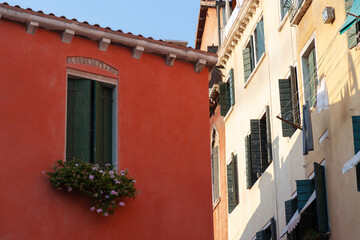 Fototapeta na wymiar Window on red building with potted plants, Venice, Italy