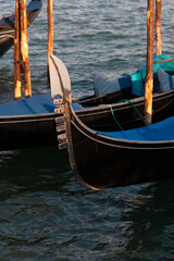 Fototapeta na wymiar Moored gondolas in a canal, Venice, Italy
