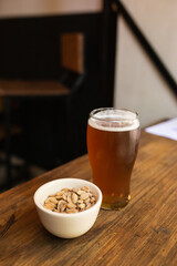 craft beer next to salted peanuts