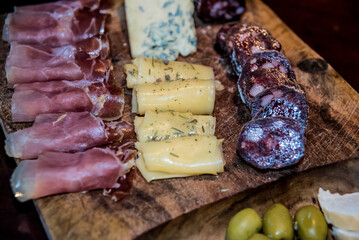 Argentine chopped with different cold cuts and olives on wooden board