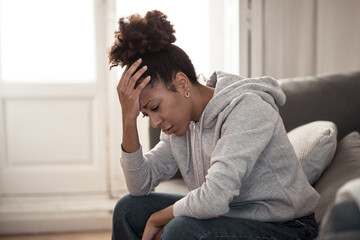 Young african american woman suffering from depression, anxiety and mental health illness