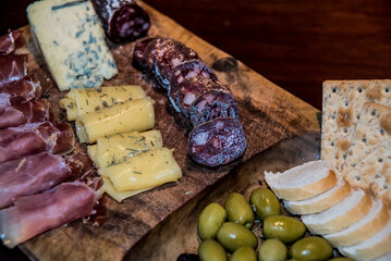 Argentine chopped with different cold cuts and olives on wooden board