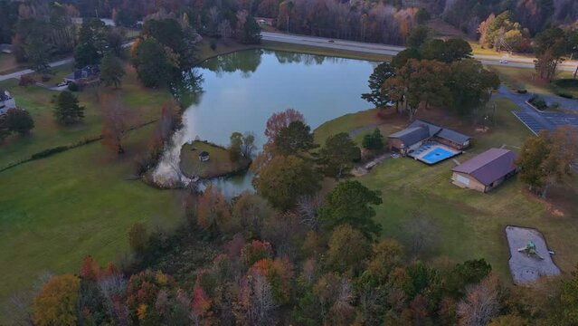 Drone aerial fly view to small two lakes fall pretty colors riverdale ga
