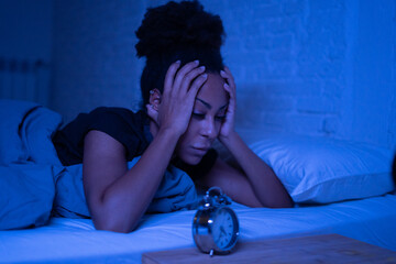 Pretty afro american woman can't sleep in insomnia and mental health concept - obrazy, fototapety, plakaty