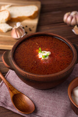red beetsoup, traditional ukrainian borshch and garlic, wooden spoon