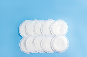 Absorbent breast pads on blue background. Concept of natural breastfeeding. Copy space © ClareM