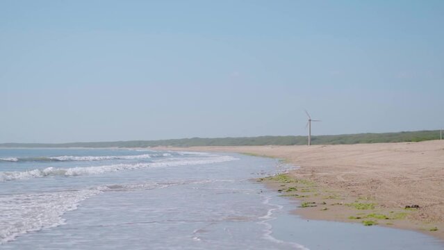 Windmills on the beach during the sunny day at Mandvi, Kutch, Gujarat, India.