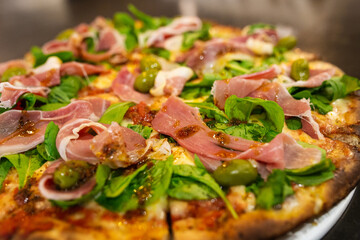 raw ham pizza and rucula