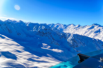 Austrian Alps covered with fresh snow during sunny winter day.