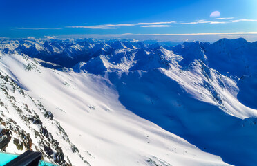 Austrian Alps covered with fresh snow during sunny winter day.