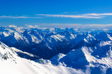 Austrian Alps covered with fresh snow during sunny winter day.