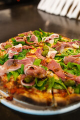 raw ham pizza and rucula