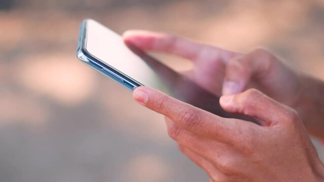 Close up shot of female hands using mobile phone. woman using application on smartphone. Texting message on blank screen smartphone. 