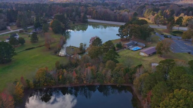 Drone Landscape over fall lake facing pretty fall lake with street in background