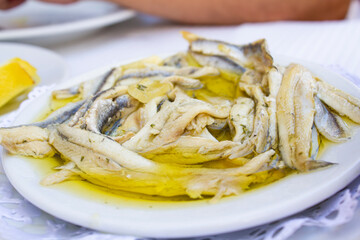 Plate with fish fillet in olive oil and vinegar