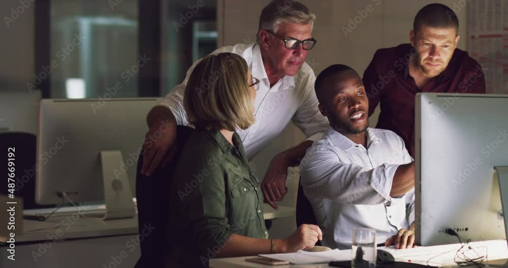 Aufkleber Business group of diverse colleagues using computer and discussing work at a table during a late night in a modern office