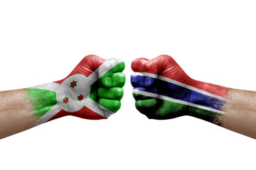 Two hands punch to each others on white background. Country flags painted fists, conflict crisis concept between burundi and gambia