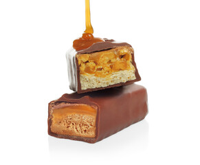 Pouring caramel on broken chocolate bars on white background