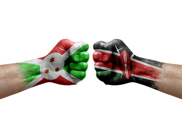 Two hands punch to each others on white background. Country flags painted fists, conflict crisis concept between burundi and kenya