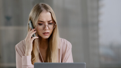 Angry caucasian woman call phone at office work place annoyed girl talking mobile conversation...