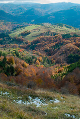 Fototapeta na wymiar Mountain scenery with green and red forests
