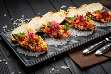 Tuna ceviches, mussels and caviar on mussel shells