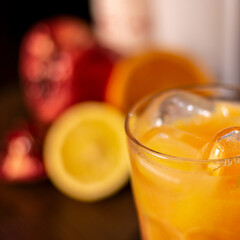 orange long drink on wooden table closeup square