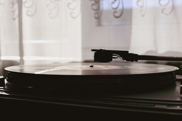 Fototapeta na wymiar Playing classic vinyl records in daylight close-up