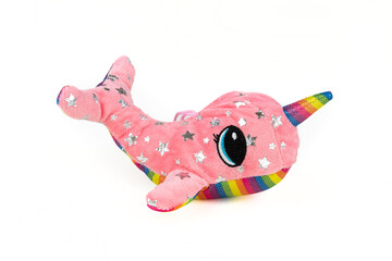 A pink whale plush with a unicorn horn