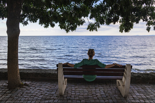 Tourist sitting on a bench on a Black Sea coast in Nesebar city, Bulgaria