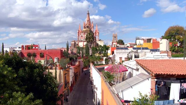 Aerial view of San Miguel de Allende, Mexico, including historic landmark Parroquia de San Miguel Arcangel on a sunny day.