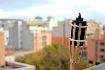 torch on a terrace with the city in the background