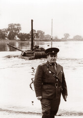 Naklejka premium Photo of a lieutenant colonel of the Soviet army at military tank exercises. Tank T64 overcomes the water barrier. The tank rides along the bottom of the river.