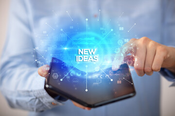 Businessman holding a foldable smartphone, new business concept