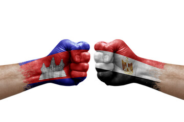 Two hands punch to each others on white background. Country flags painted fists, conflict crisis concept between cambodia and egypt